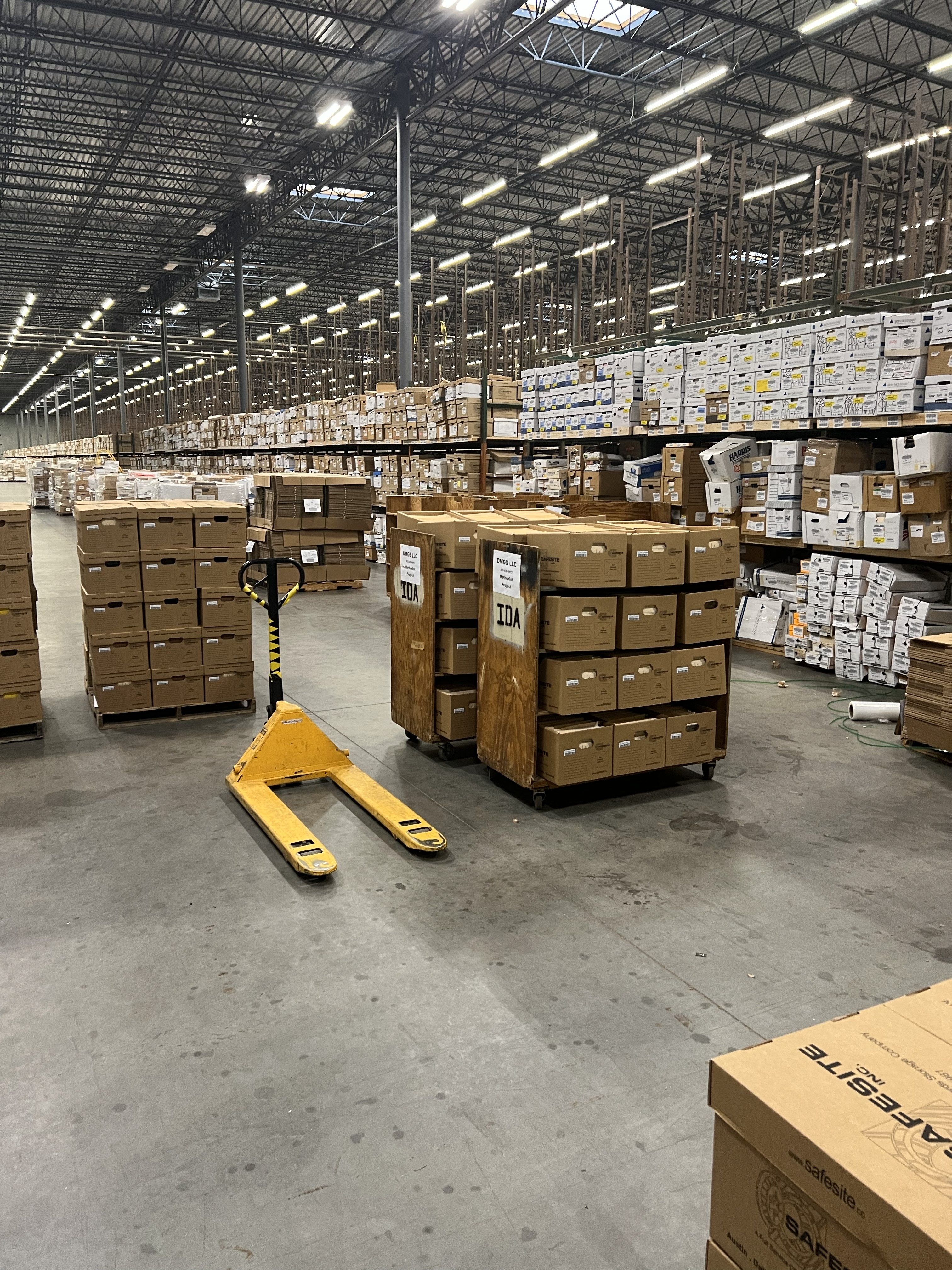 Records management team organizing and classifying physical documents at client site in Houston, Texas